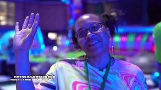 a woman in front of an inflatable games course