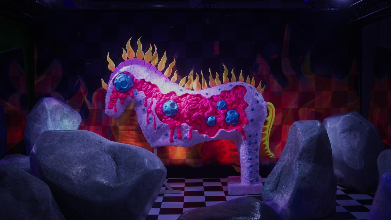pink horse with flames in a dark room