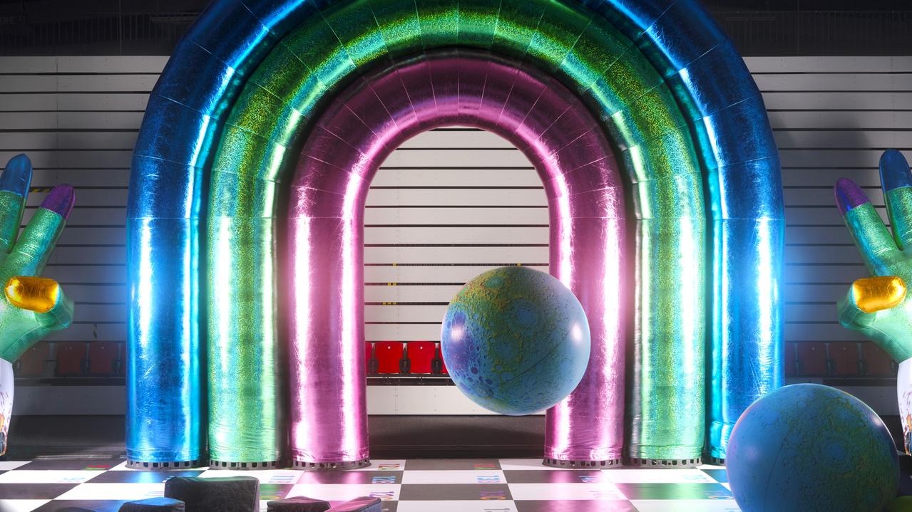inflatable metallic archway and a floating globe in a large hall