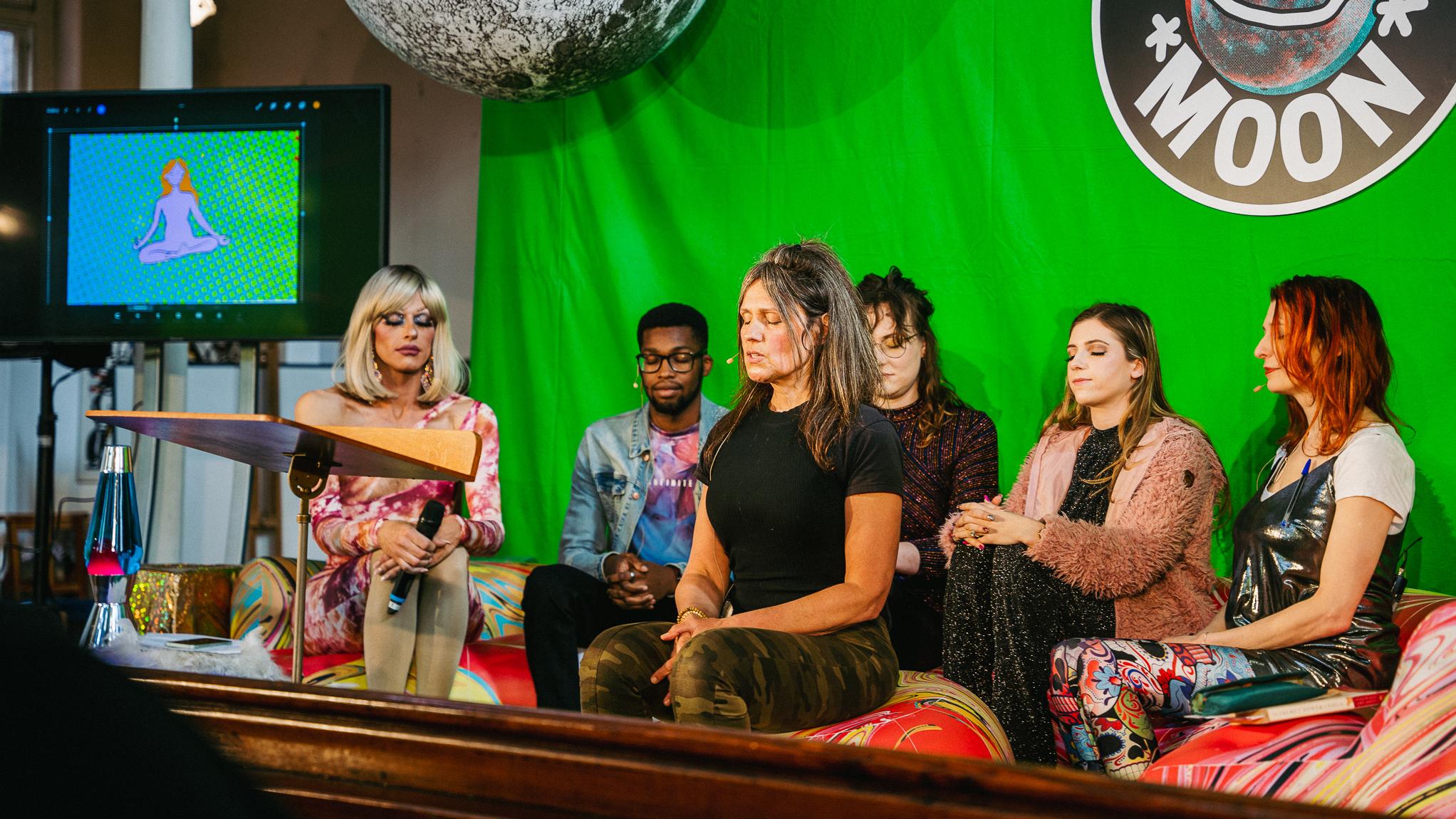 people meditating in front of green screen