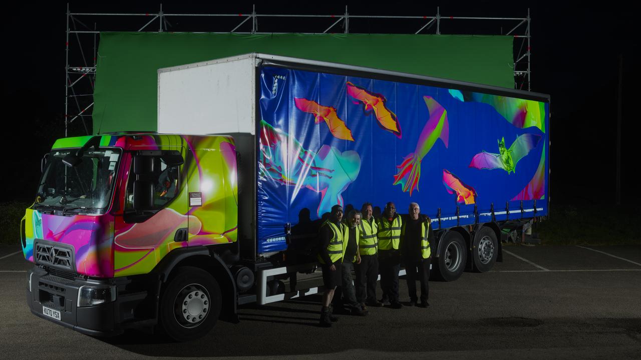 blue truck with images of bats and squids on it