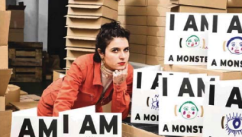 nelly ben-hayoun next to boxes of books